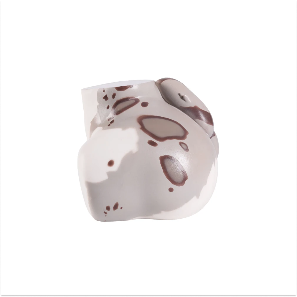 Side view of the Shira silicone snow leopard furry torso with spotted markings and a sculpted curled tail